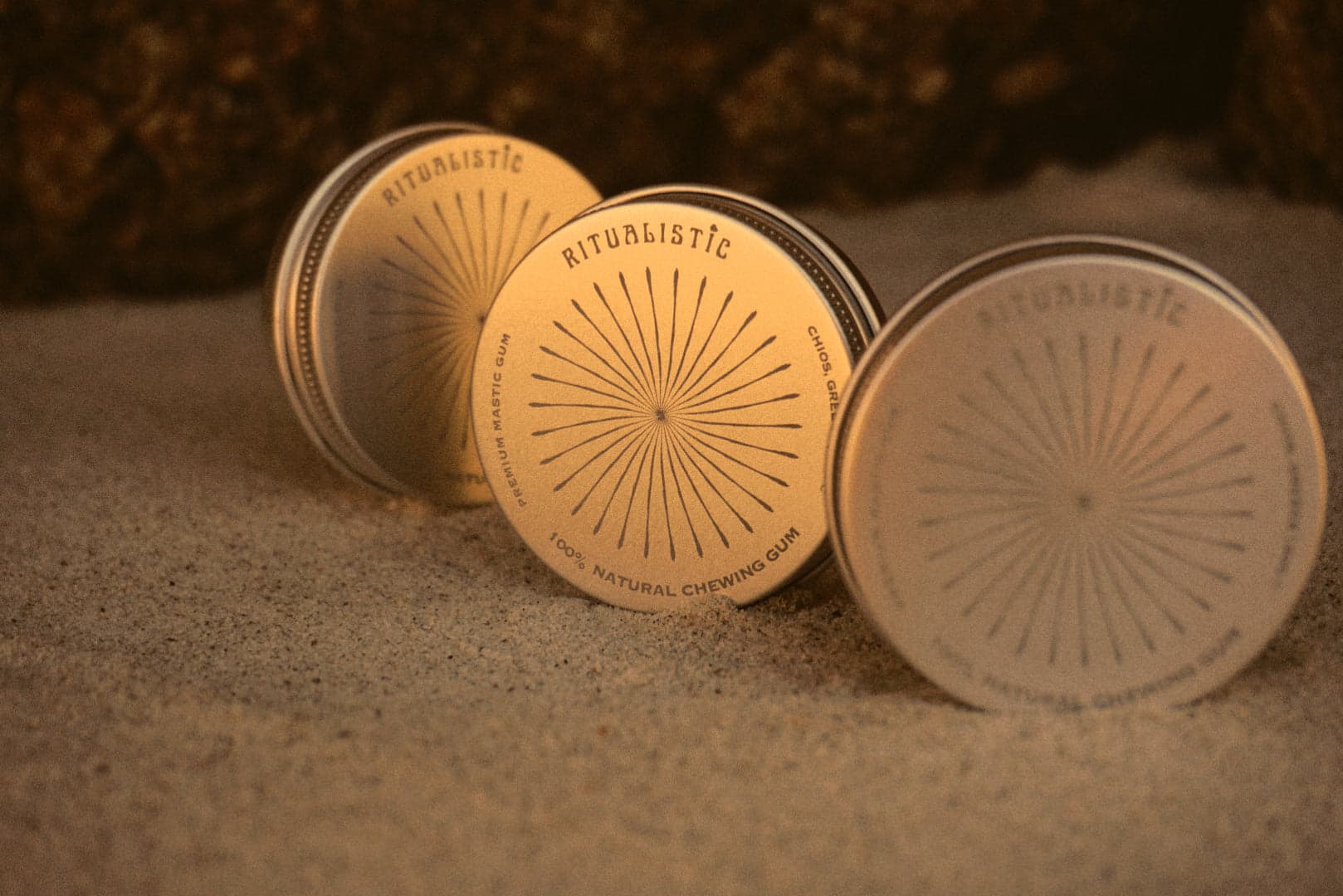Three Ritualistic tins half buried in golden sand.